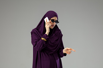 Image showing Beautiful arab woman posing in stylish hijab isolated on studio background. Fashion concept