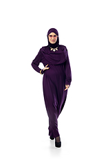 Image showing Beautiful arab woman posing in stylish hijab isolated on studio background. Fashion concept