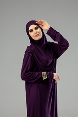 Image showing Beautiful arab woman posing in stylish hijab isolated on studio background. Fashion concept