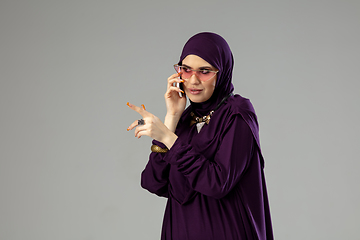 Image showing Beautiful arab woman posing in stylish hijab isolated on studio background. Fashion concept