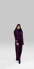 Image showing Beautiful arab woman posing in stylish hijab isolated on studio background. Fashion concept