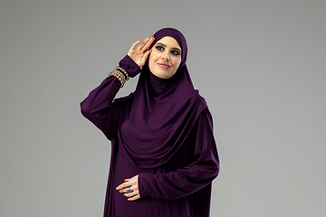 Image showing Beautiful arab woman posing in stylish hijab isolated on studio background. Fashion concept