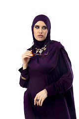 Image showing Beautiful arab woman posing in stylish hijab isolated on studio background. Fashion concept