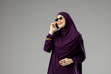 Image showing Beautiful arab woman posing in stylish hijab isolated on studio background. Fashion concept