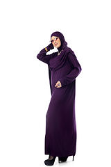 Image showing Beautiful arab woman posing in stylish hijab isolated on studio background. Fashion concept