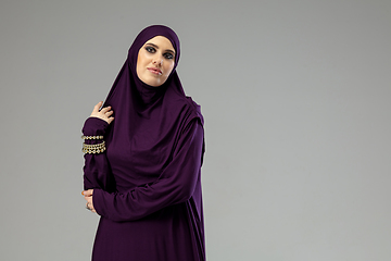 Image showing Beautiful arab woman posing in stylish hijab isolated on studio background. Fashion concept