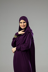 Image showing Beautiful arab woman posing in stylish hijab isolated on studio background. Fashion concept