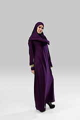 Image showing Beautiful arab woman posing in stylish hijab isolated on studio background. Fashion concept