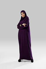 Image showing Beautiful arab woman posing in stylish hijab isolated on studio background. Fashion concept