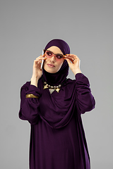 Image showing Beautiful arab woman posing in stylish hijab isolated on studio background. Fashion concept