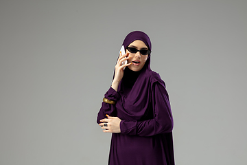 Image showing Beautiful arab woman posing in stylish hijab isolated on studio background. Fashion concept