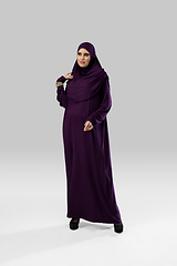 Image showing Beautiful arab woman posing in stylish hijab isolated on studio background. Fashion concept