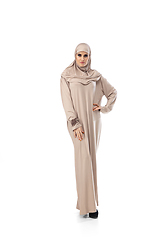 Image showing Beautiful arab woman posing in stylish hijab isolated on studio background. Fashion concept