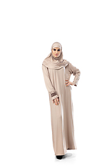 Image showing Beautiful arab woman posing in stylish hijab isolated on studio background. Fashion concept