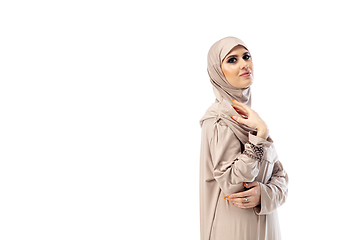 Image showing Beautiful arab woman posing in stylish hijab isolated on studio background. Fashion concept