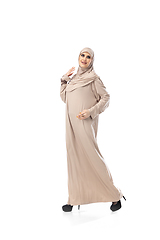 Image showing Beautiful arab woman posing in stylish hijab isolated on studio background. Fashion concept