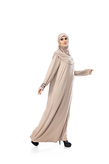 Image showing Beautiful arab woman posing in stylish hijab isolated on studio background. Fashion concept