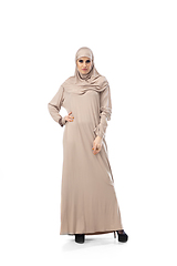 Image showing Beautiful arab woman posing in stylish hijab isolated on studio background. Fashion concept