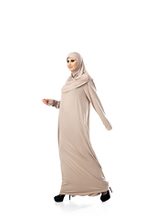 Image showing Beautiful arab woman posing in stylish hijab isolated on studio background. Fashion concept