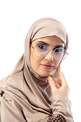 Image showing Beautiful arab woman posing in stylish hijab isolated on studio background. Fashion concept