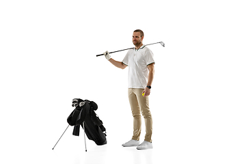 Image showing Golf player in a white shirt practicing, playing isolated on white studio background