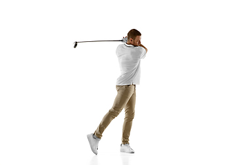 Image showing Golf player in a white shirt taking a swing isolated on white studio background