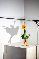 Image showing Flying food composition making beautiful ballerina drawing shadow on the wall