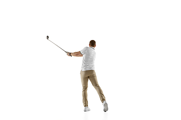 Image showing Golf player in a white shirt taking a swing isolated on white studio background