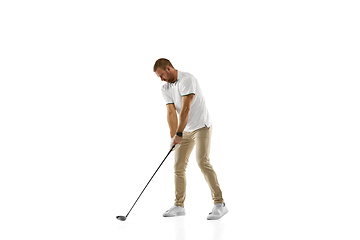 Image showing Golf player in a white shirt practicing, playing isolated on white studio background