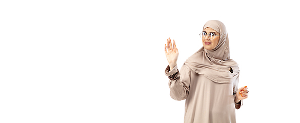 Image showing Beautiful arab woman posing in stylish hijab isolated on studio background. Fashion concept