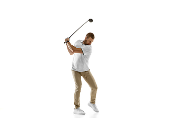 Image showing Golf player in a white shirt taking a swing isolated on white studio background