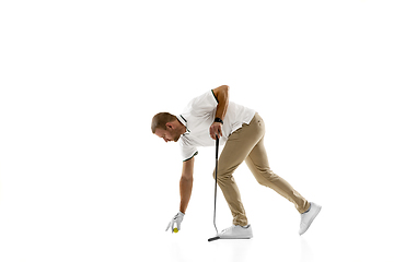 Image showing Golf player in a white shirt practicing, playing isolated on white studio background