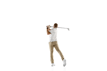 Image showing Golf player in a white shirt taking a swing isolated on white studio background