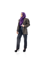 Image showing Beautiful arab woman posing in stylish office attire isolated on studio background. Fashion concept