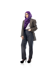 Image showing Beautiful arab woman posing in stylish office attire isolated on studio background. Fashion concept