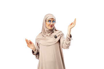 Image showing Beautiful arab woman posing in stylish hijab isolated on studio background. Fashion concept