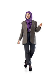 Image showing Beautiful arab woman posing in stylish office attire isolated on studio background. Fashion concept