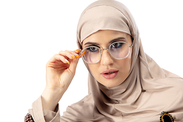 Image showing Beautiful arab woman posing in stylish hijab isolated on studio background. Fashion concept