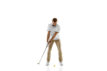 Image showing Golf player in a white shirt practicing, playing isolated on white studio background