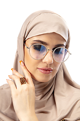 Image showing Beautiful arab woman posing in stylish hijab isolated on studio background. Fashion concept