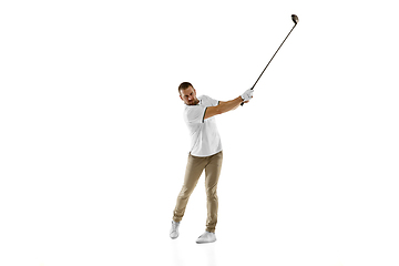 Image showing Golf player in a white shirt taking a swing isolated on white studio background