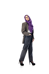 Image showing Beautiful arab woman posing in stylish office attire isolated on studio background. Fashion concept