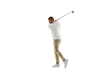 Image showing Golf player in a white shirt taking a swing isolated on white studio background