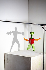 Image showing Flying food composition making beautiful sportsman drawing shadow on the wall