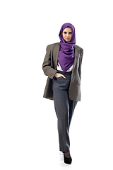 Image showing Beautiful arab woman posing in stylish office attire isolated on studio background. Fashion concept