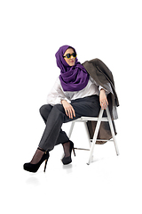 Image showing Beautiful arab woman posing in stylish office attire isolated on studio background. Fashion concept