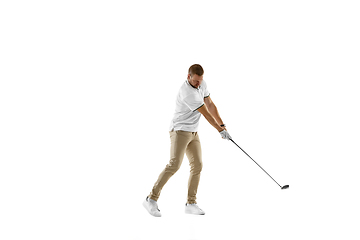 Image showing Golf player in a white shirt taking a swing isolated on white studio background