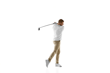 Image showing Golf player in a white shirt taking a swing isolated on white studio background