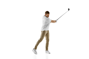 Image showing Golf player in a white shirt taking a swing isolated on white studio background