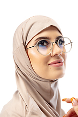 Image showing Beautiful arab woman posing in stylish hijab isolated on studio background. Fashion concept